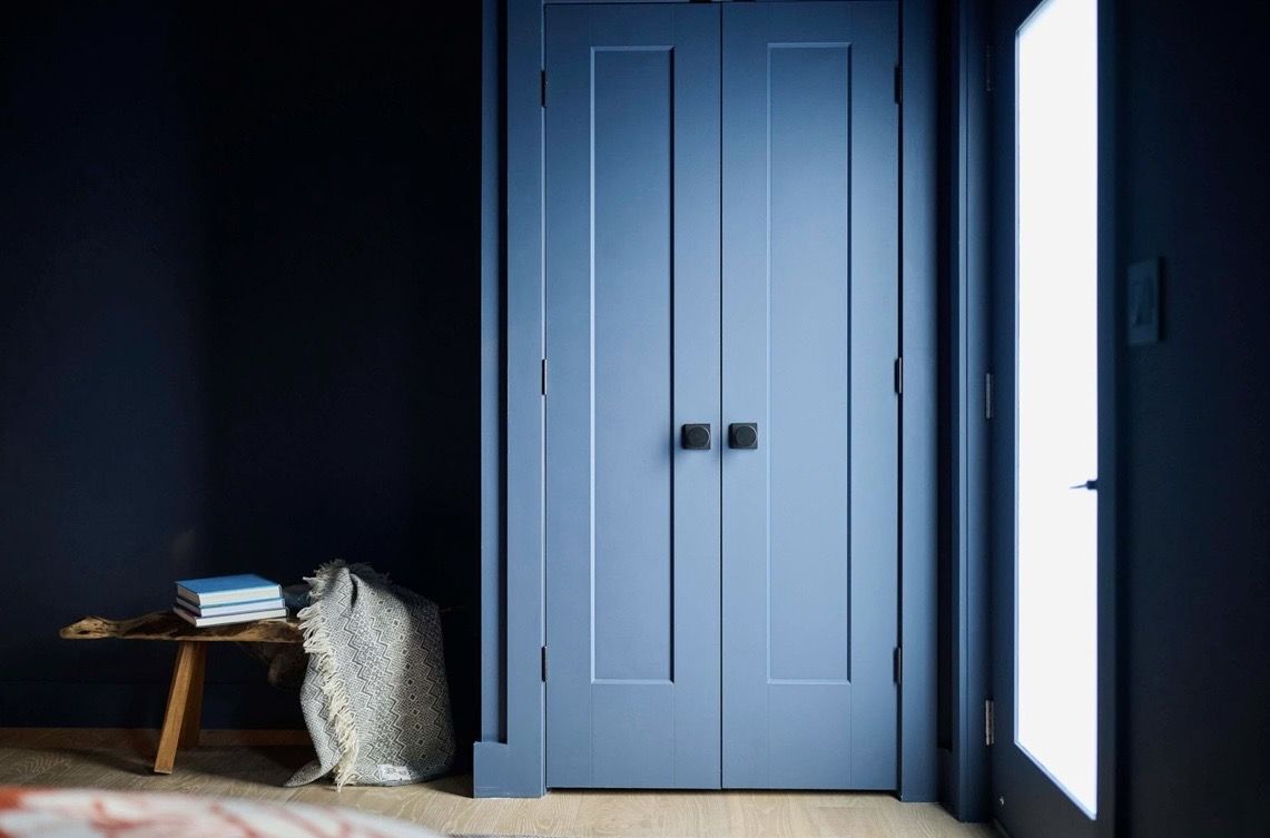 Navy double doors in a bedroom entry